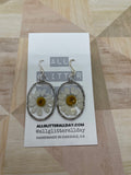 Pressed white daisy flower in resin oval dangle earring